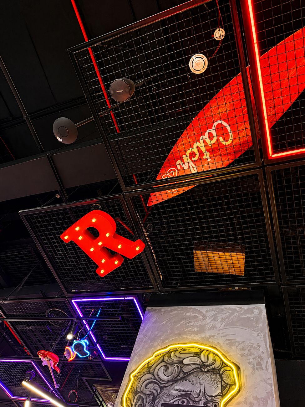 Catch 22 ceiling detail with marquee letter and neon frames, Mirdiff City Centre