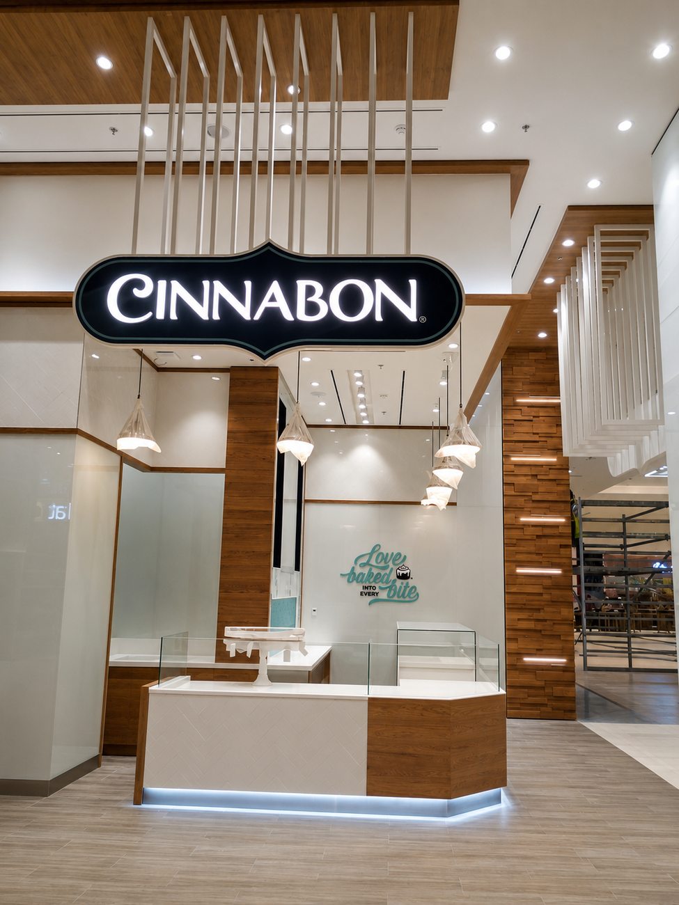 Cinnabon storefront angled view with tagline wall, Ajman City Centre
