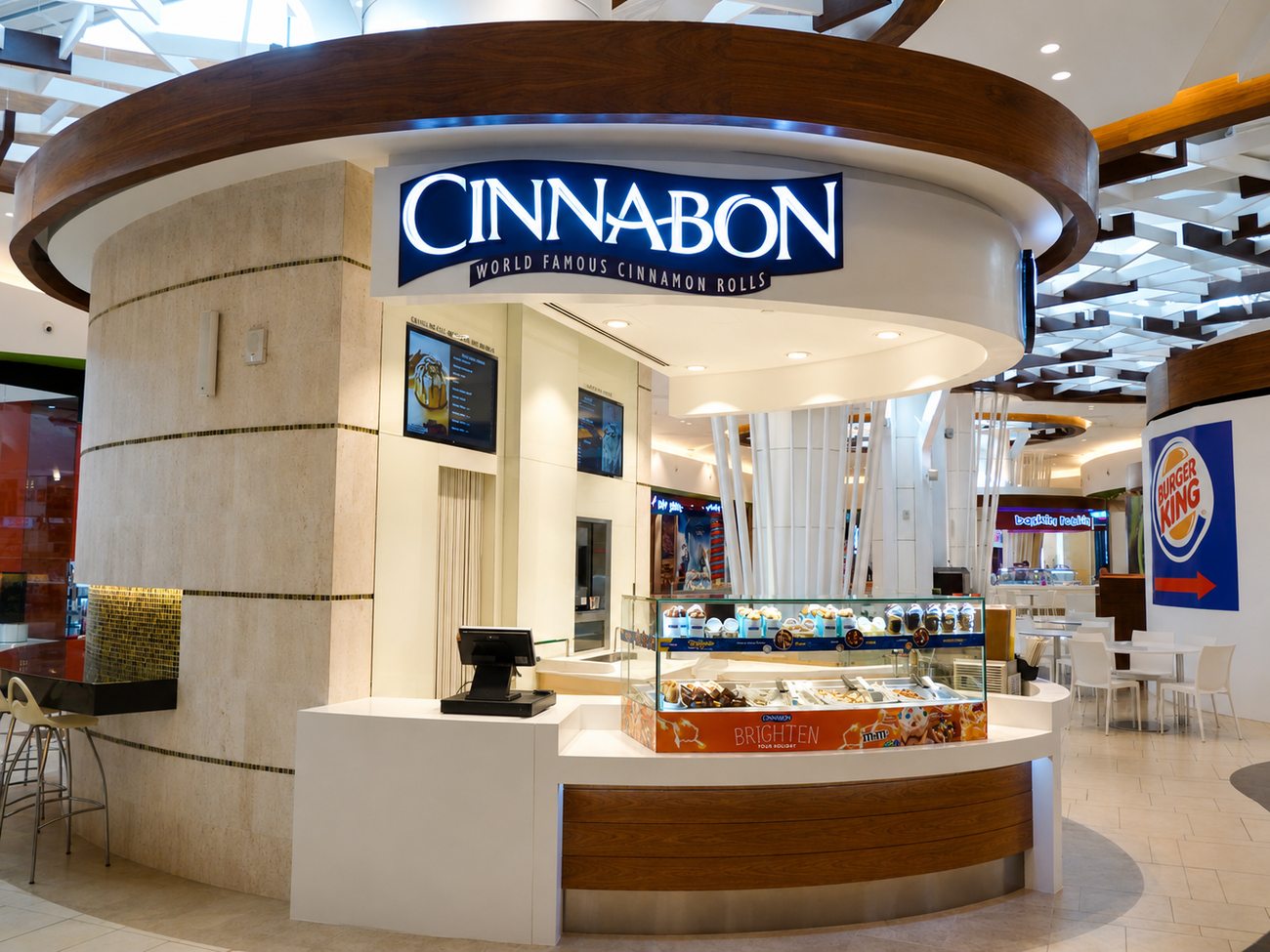 Cinnabon kiosk angled view with Burger King signage beyond, Yas Mall