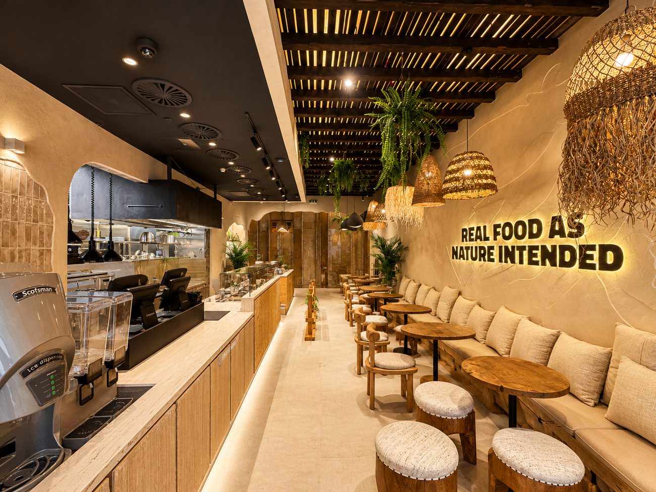 Flavour Fields dining floor wide view with rattan pendant lighting and banquette seating, Dubai Galleria Mall