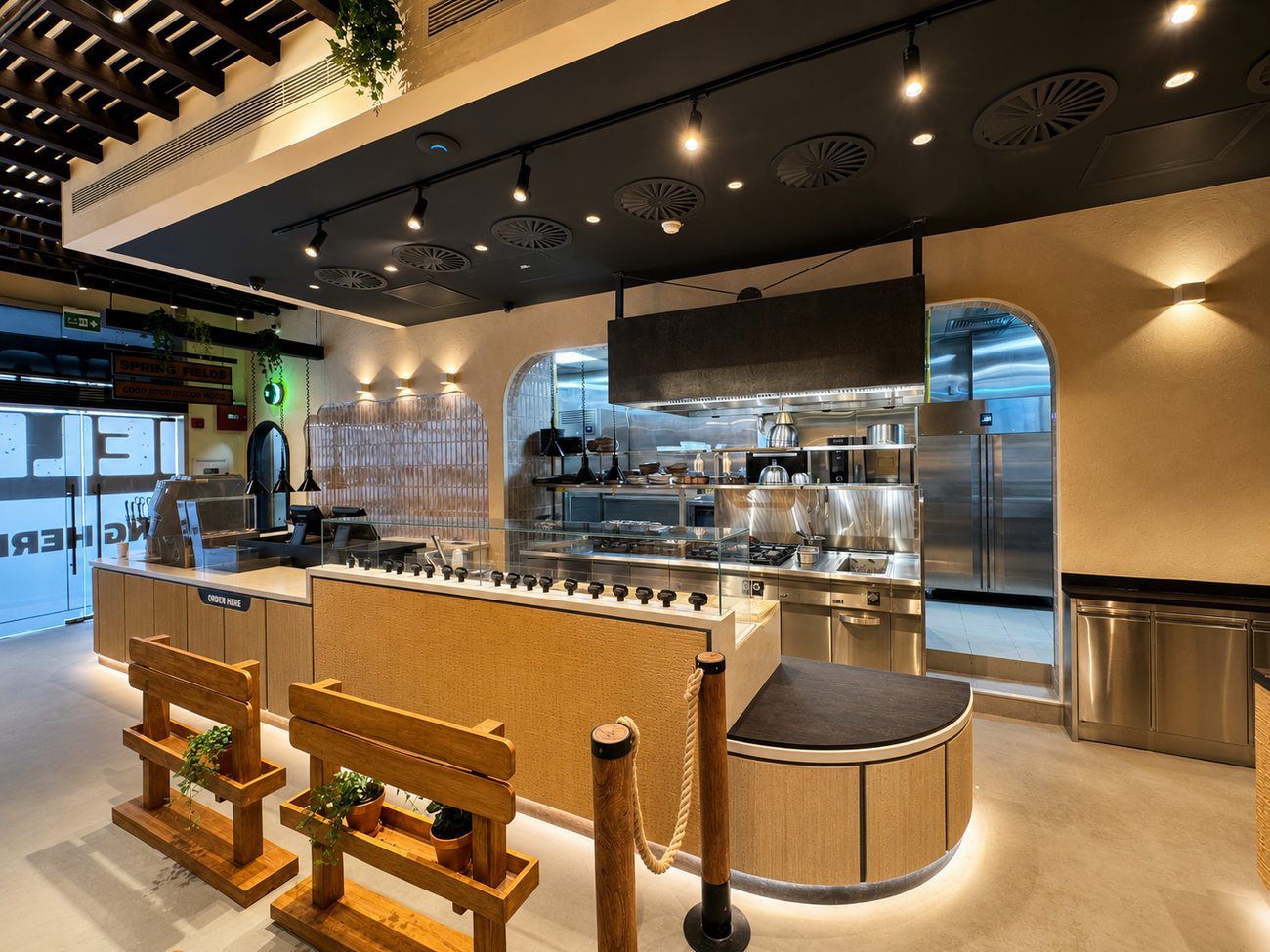 Flavour Fields curved order counter with open kitchen beyond, Dubai Galleria Mall