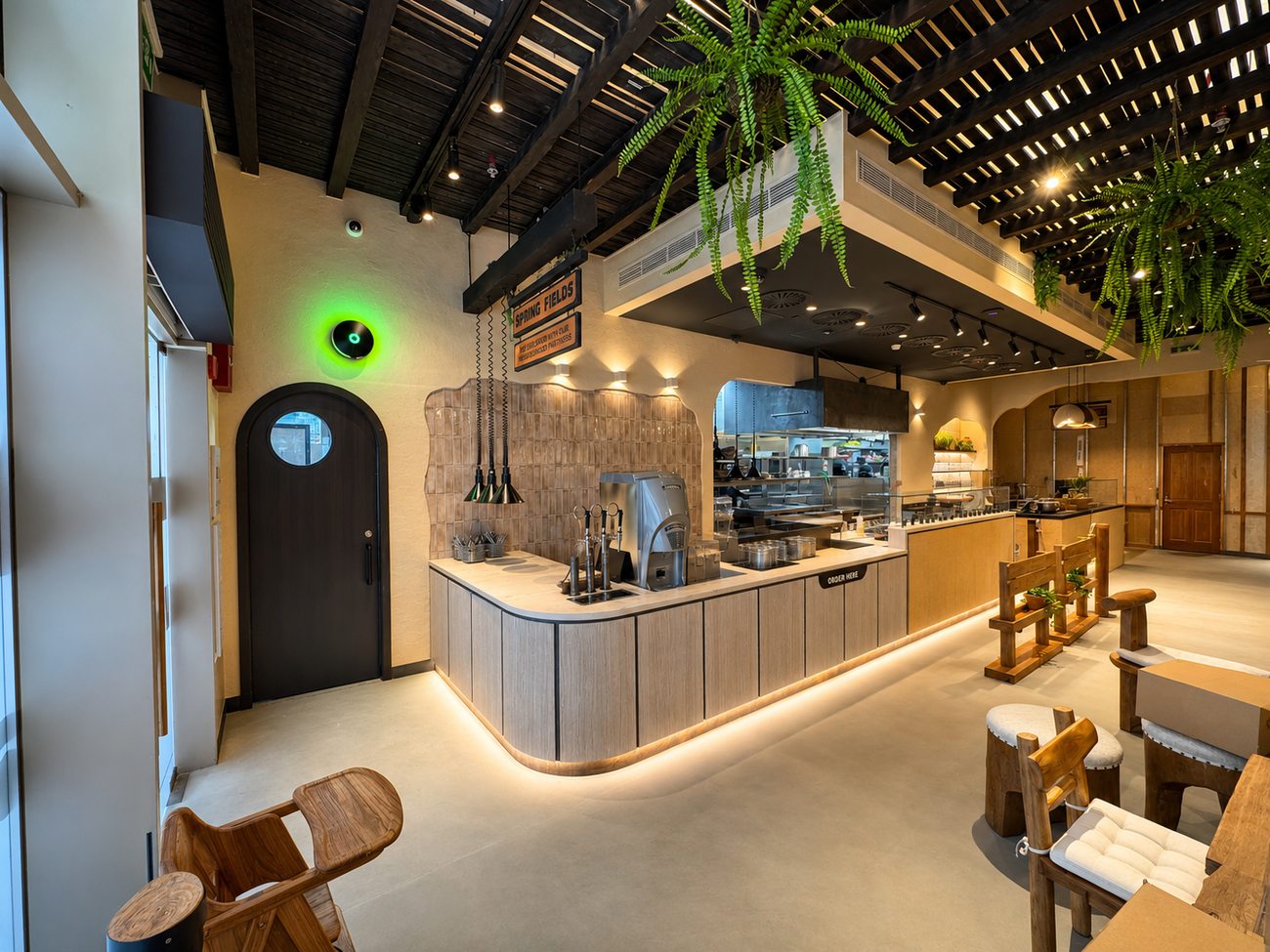 Flavour Fields order counter and drinks fountain taps beside the arched entrance door, Dubai Galleria Mall