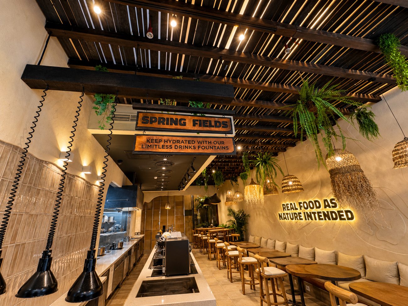 Spring Fields self-serve drinks fountain signage beneath the pergola ceiling at Flavour Fields, Dubai Galleria Mall