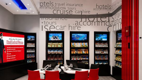 Flight Centre agent desk and destination TV wall, by Davies Group UAE