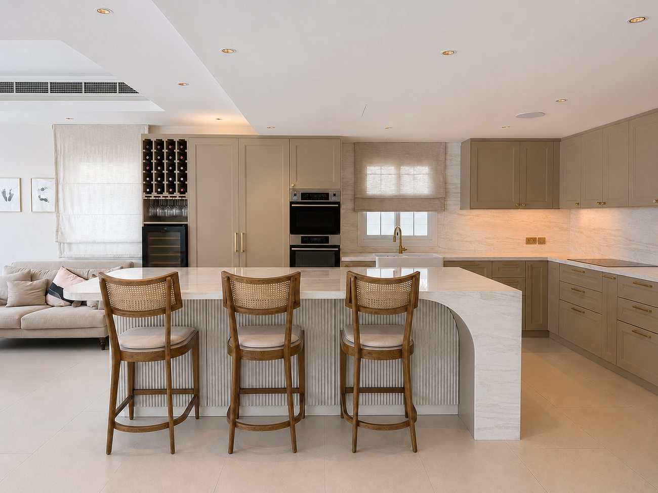 JVT Villa kitchen island with curved White Rhino marble waterfall countertop