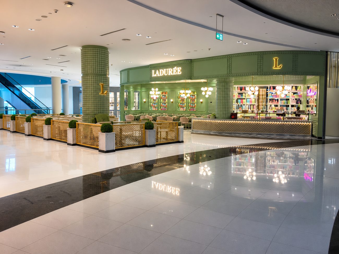 Laduree exterior terrace seating with gold lattice fencing, The Dubai Mall