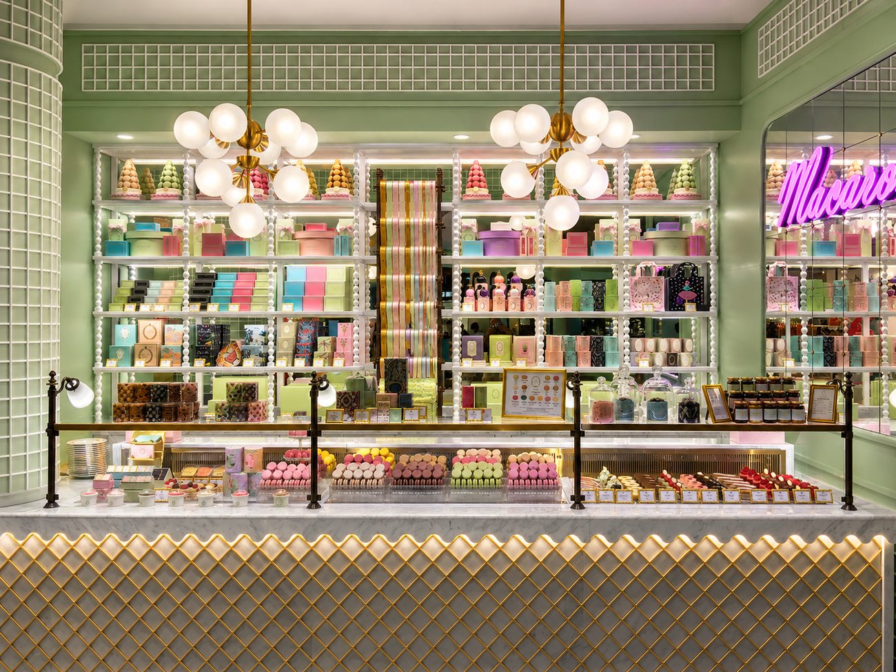 Laduree storefront counter interior with Macaron neon sign, The Dubai Mall