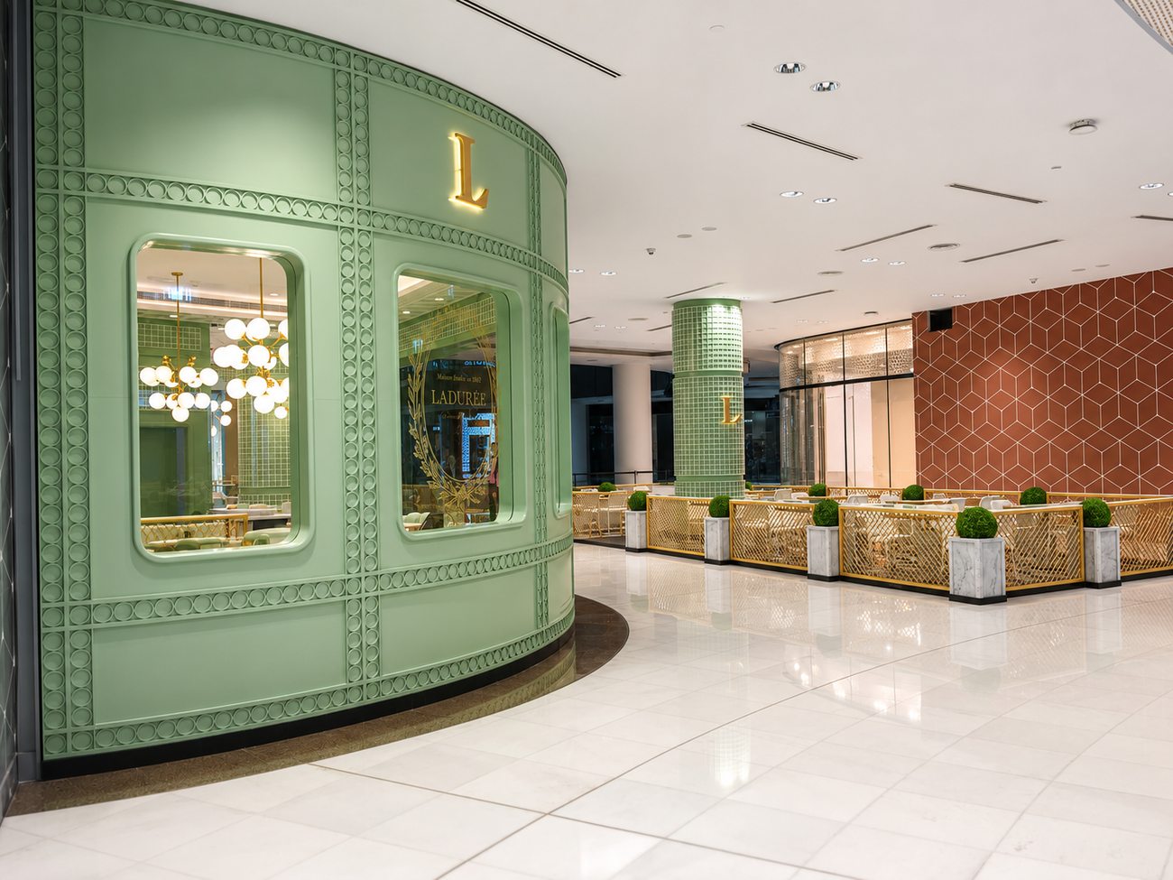 Laduree storefront exterior beside a terracotta tiled neighbouring wall, The Dubai Mall