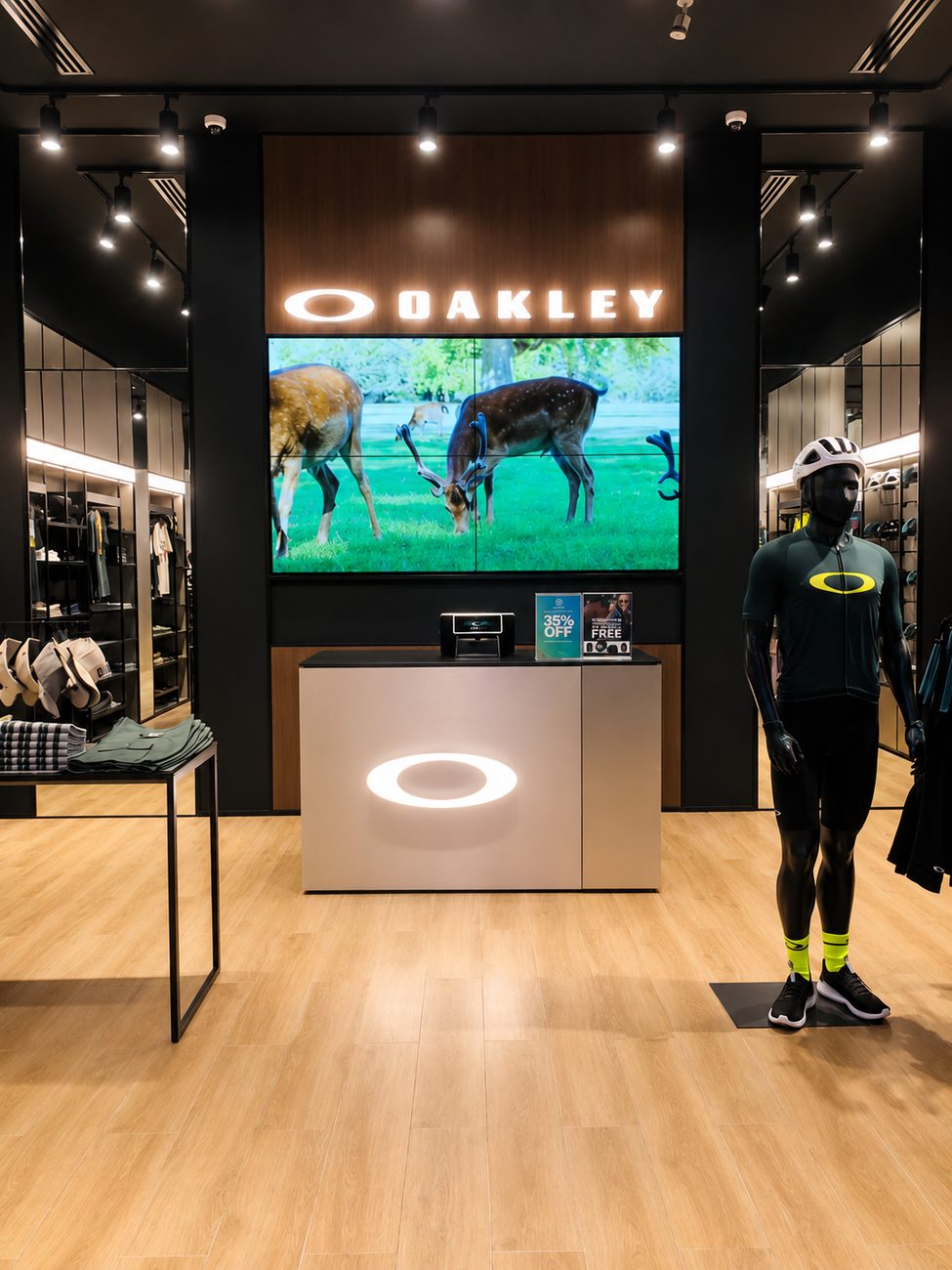 Oakley brand wall with video screen and cycling mannequin, Yas Mall, Abu Dhabi