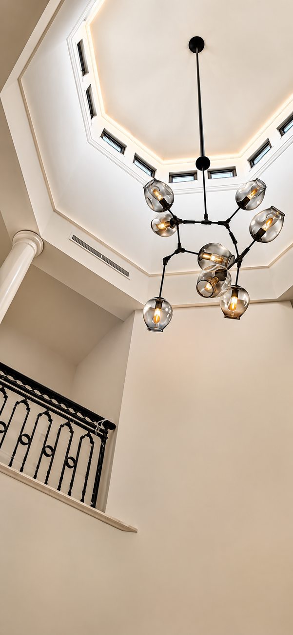 Palm Villa — Stairwell Chandelier & High Ceiling