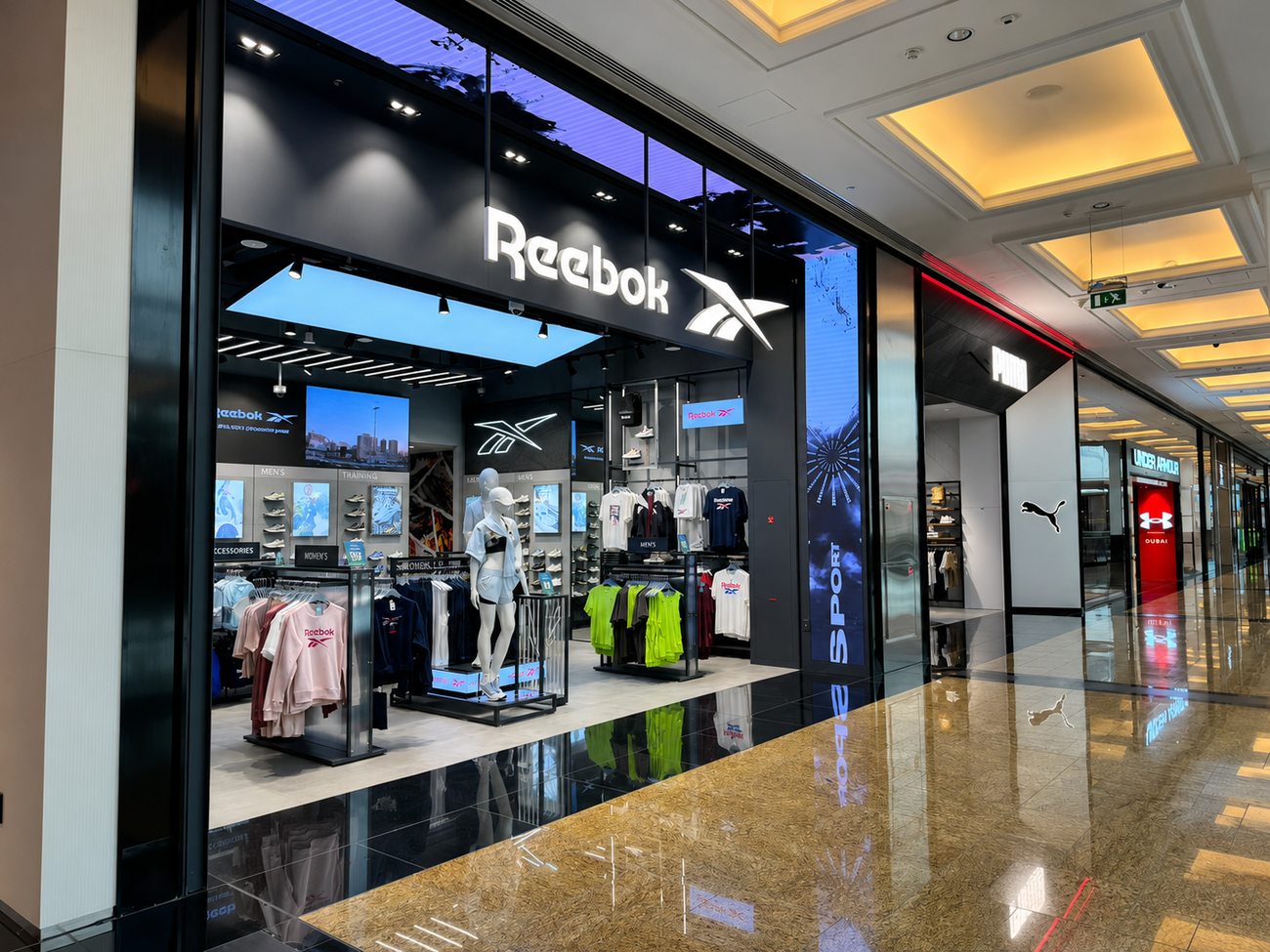 Reebok storefront angled view with neighbouring Puma and Under Armour stores, Mall of the Emirates
