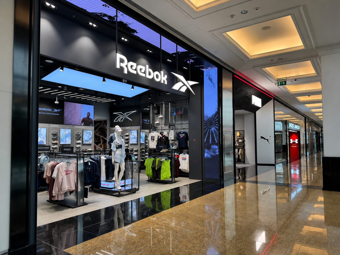 Reebok storefront and mall corridor view with neighbouring stores, Mall of the Emirates