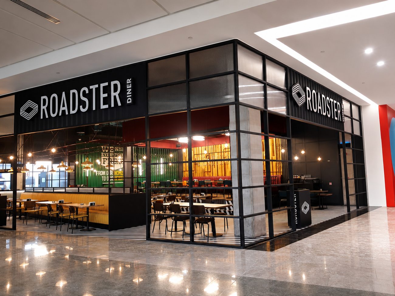 Roadster Diner corner storefront exterior with dual entrance, Mirdiff City Centre