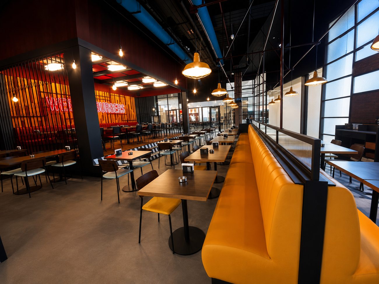 Roadster Diner dining hall with yellow booths and neon wall, Mirdiff City Centre