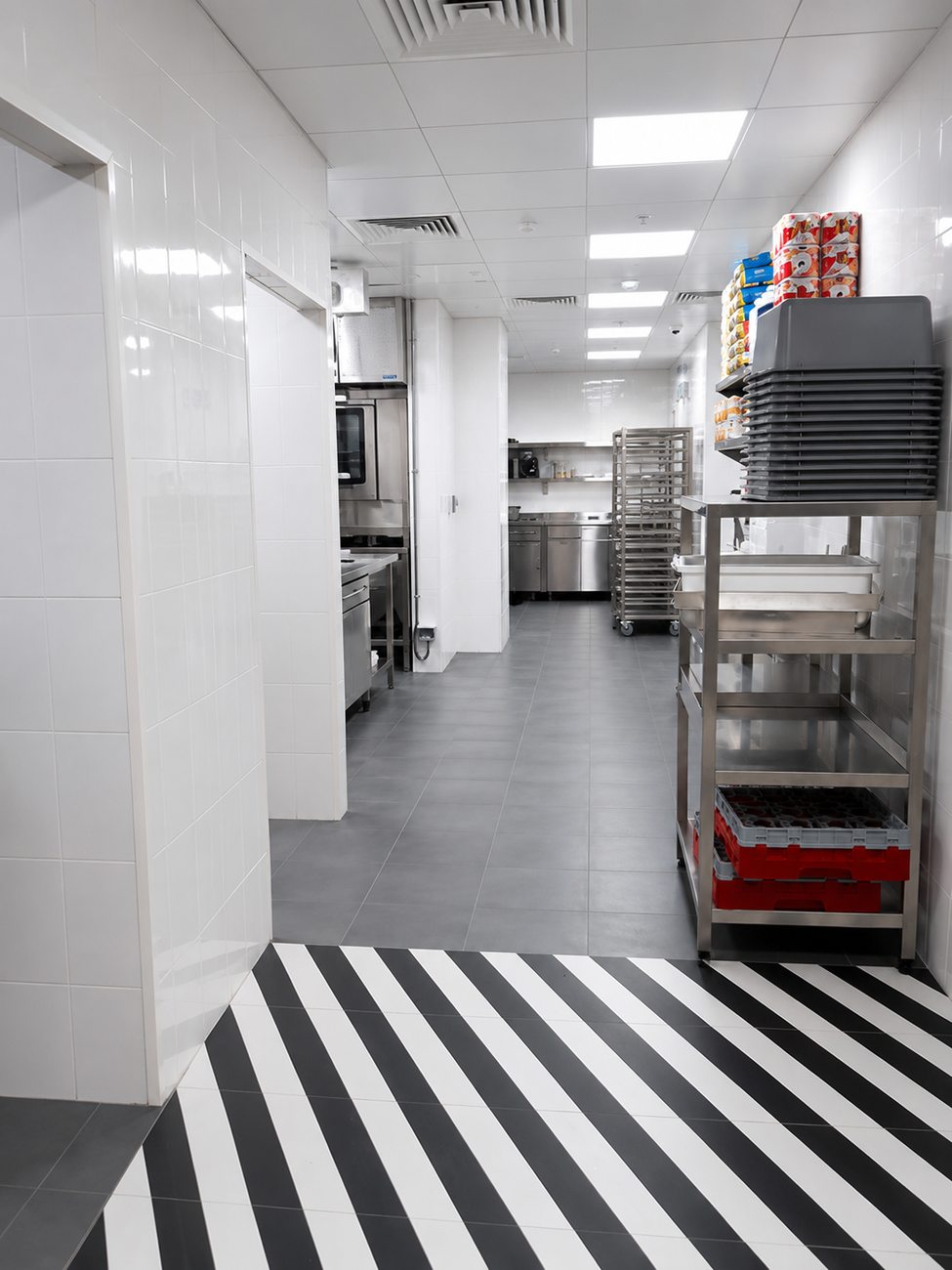 Roadster Diner back-of-house corridor with striped floor, Mirdiff City Centre