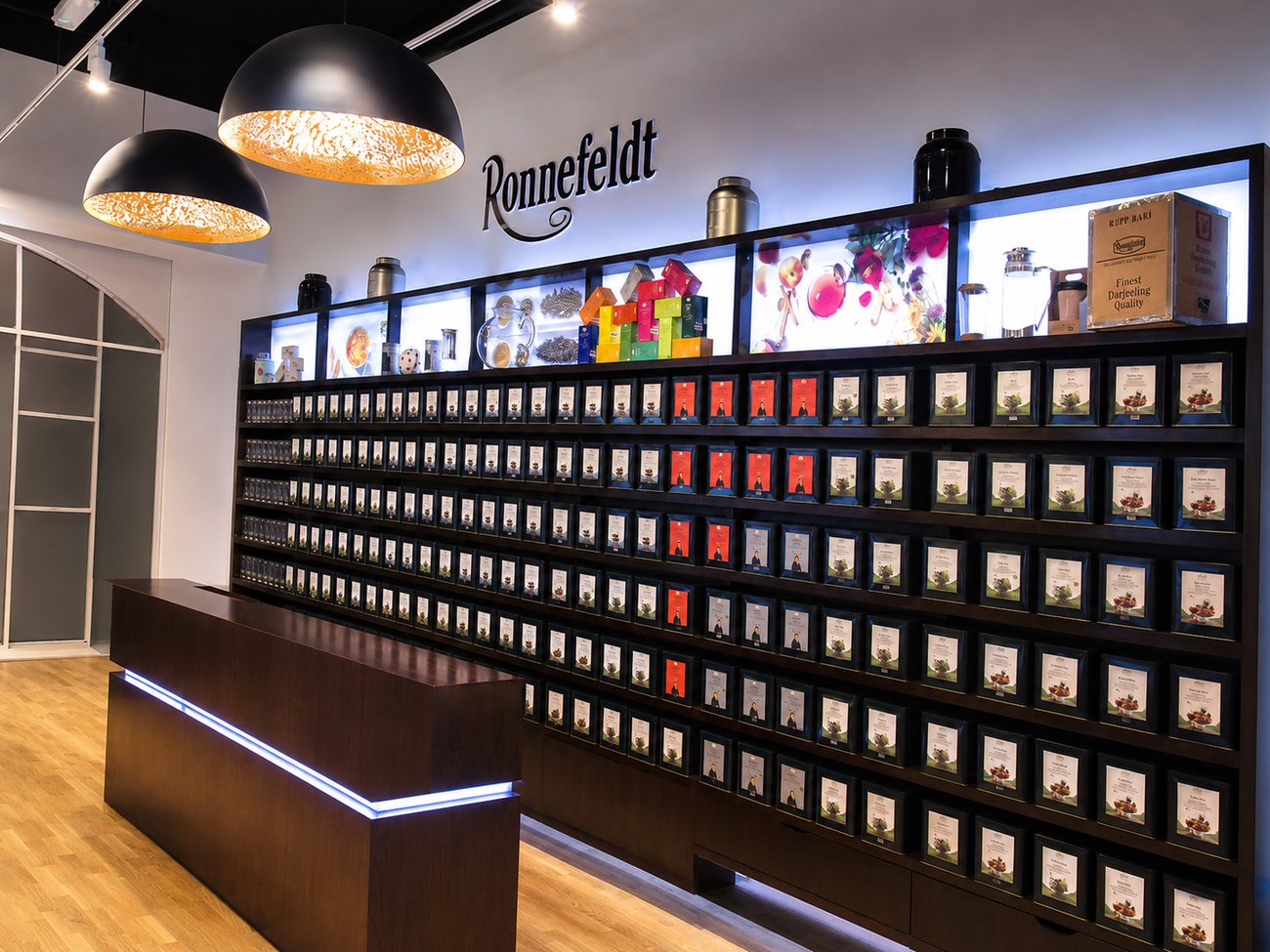 Ronnefeldt walnut tea-canister wall with backlit product panels, Mercato Mall